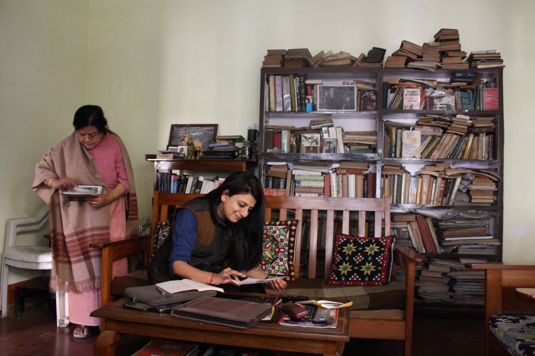  Anubha Bhonsle in a room with a large book shelf and lots of books